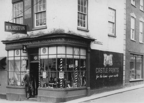 W A Bruton outside his shop, 18 Long Street